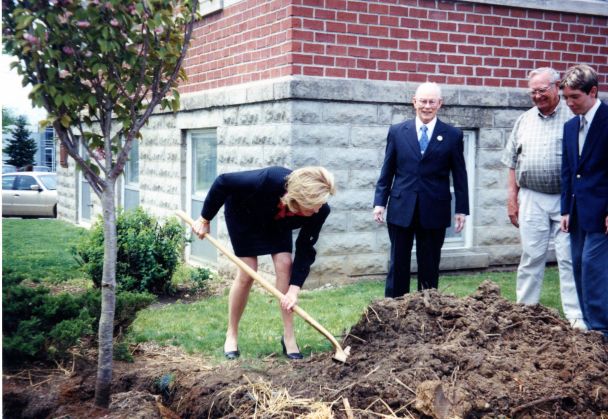 Lori Houser Holden planting tree